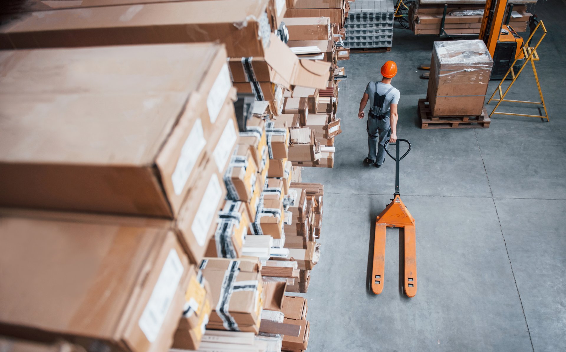 top-view-of-male-worker-in-warehouse-with-pallet-t-2023-11-27-04-52-07-utc