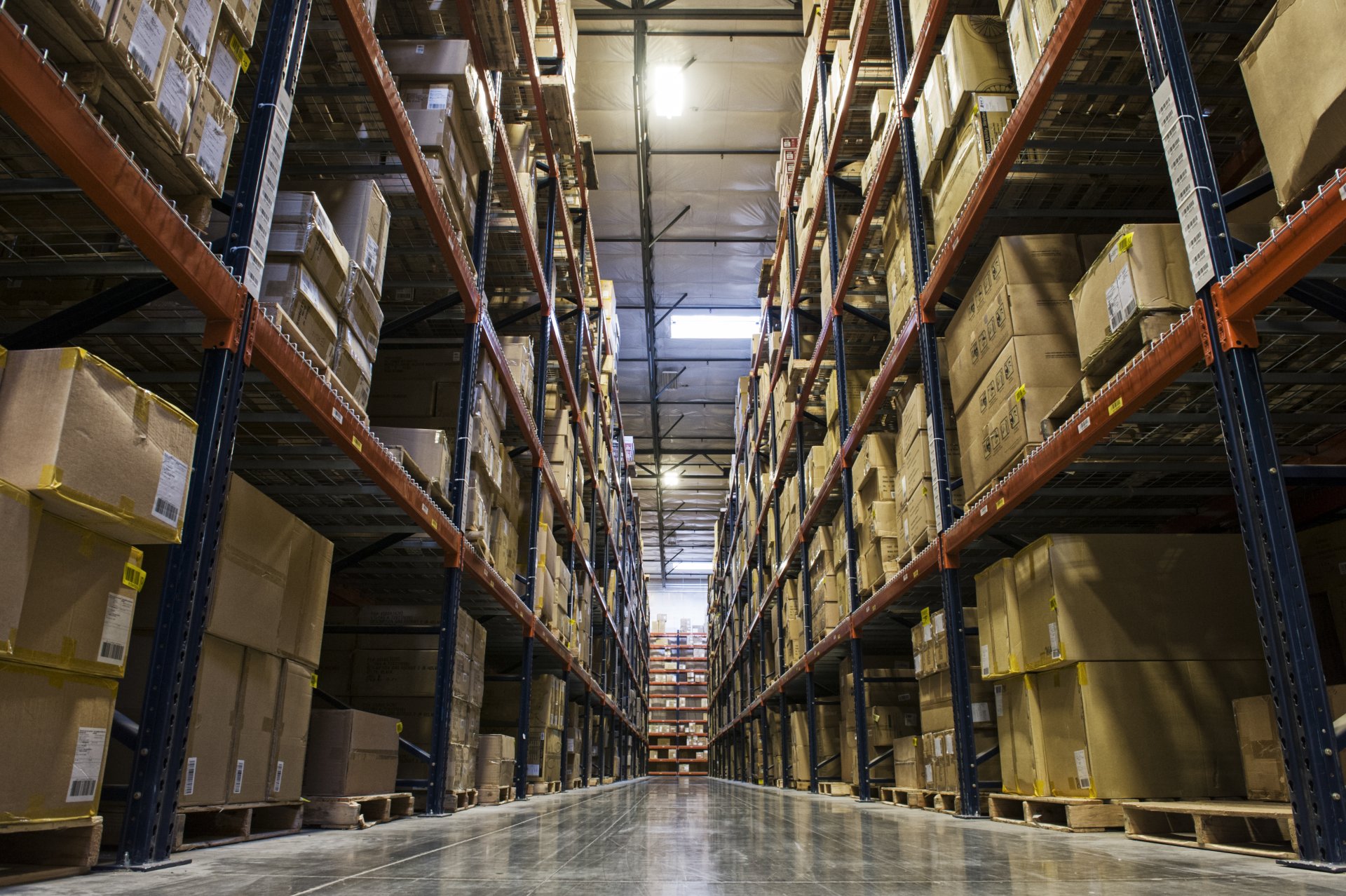 view-down-an-aisle-of-racks-holding-cardboard-boxe-2023-11-27-05-28-55-utc