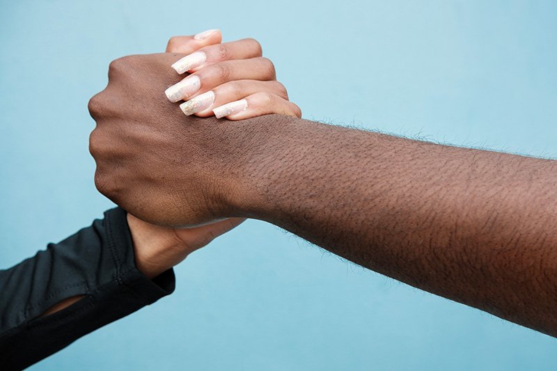 man-and-woman-shaking-hands-close-up-and-blue-bac-2024-03-27-03-44-47-utc