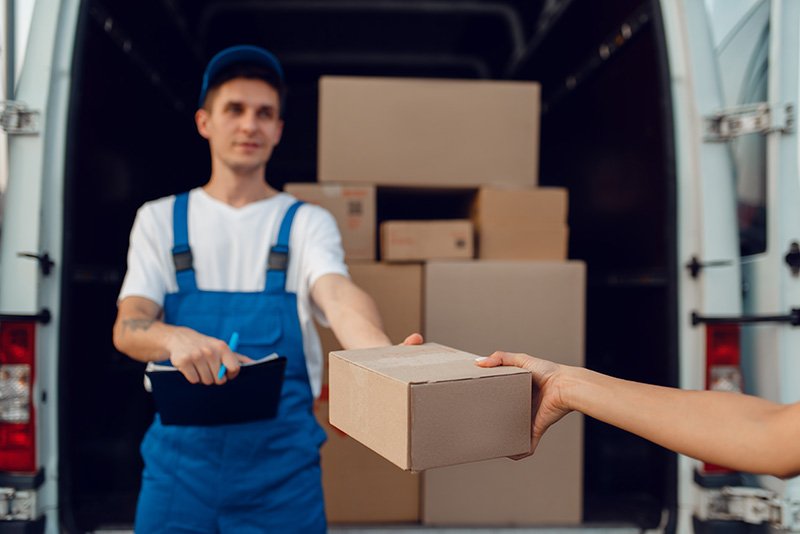 deliveryman-gives-parcel-to-buyer-delivering-2023-11-27-05-07-55-utc
